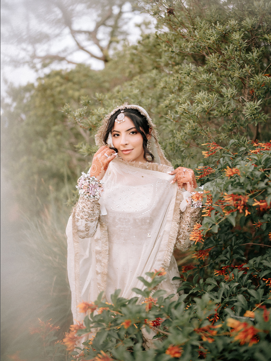 Indian Wedding Photographer in Miami 6 Bride in an ivory dupatta among orange flowers, Pakistani wedding photographer Miami