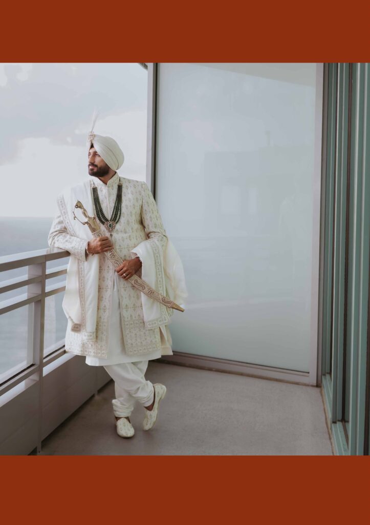 Groom in an ivory sherwani and turban on an ocean-view balcony, The Diplomat Beach Resort