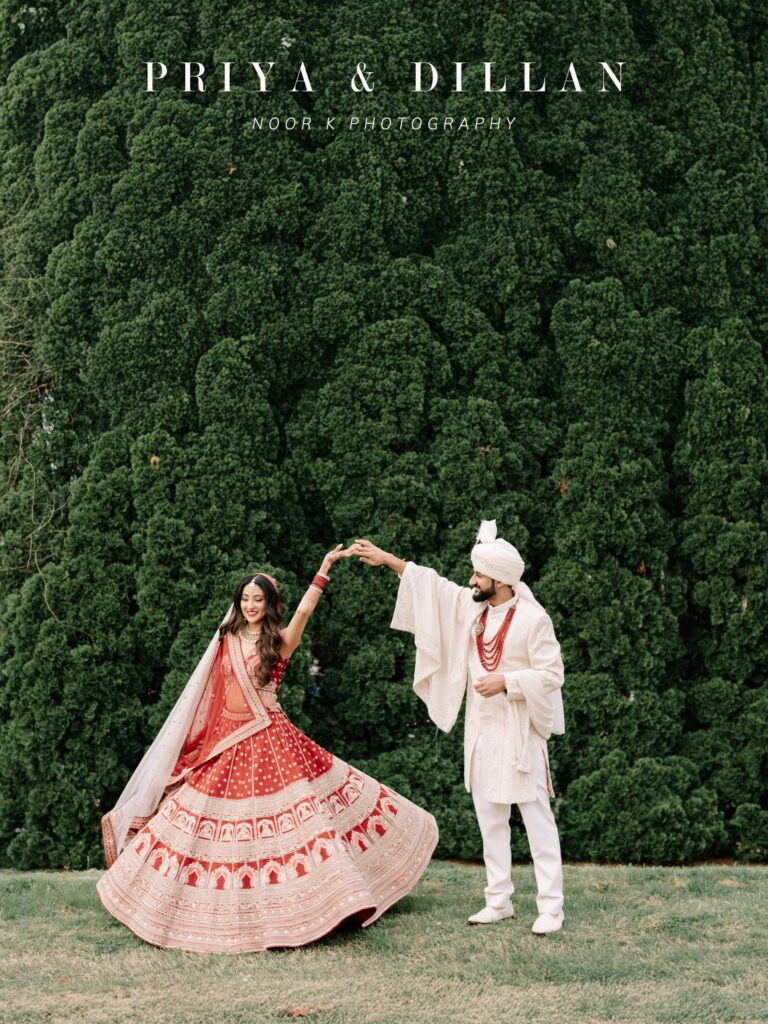 Priya & Dillan’s Gujarati Wedding | Indian Wedding Photographer Atlanta 1 Priya twirling in a red and ivory lehenga as Dillan in an ivory sherwani and safa spins her in front of a tall green hedge, Atlanta Gujarati wedding by Noor K Photography