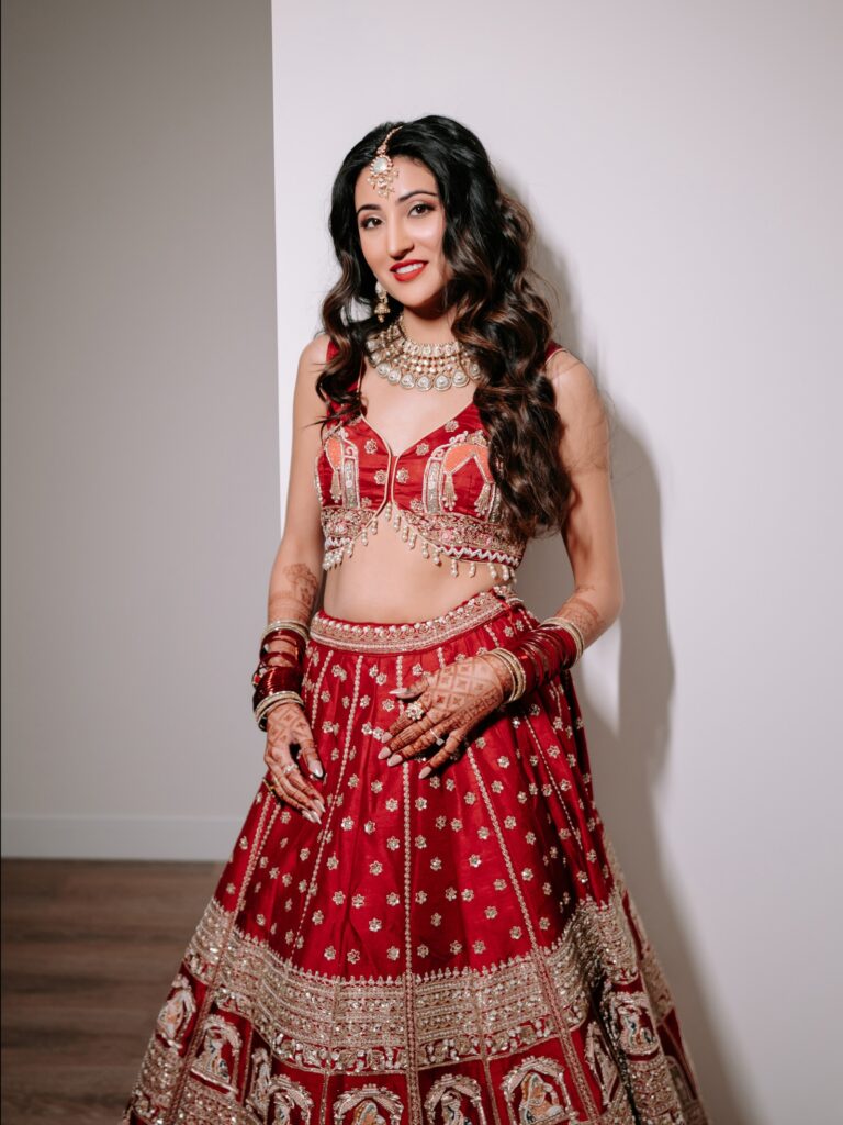 Priya & Dillan’s Gujarati Wedding | Indian Wedding Photographer Atlanta 10 Gujarati bride in a red and gold embroidered lehenga with a red choli, getting-ready portrait