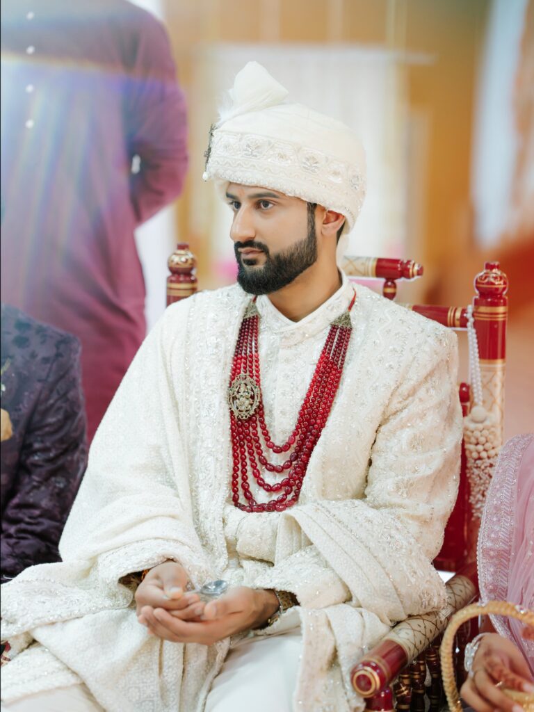 Priya & Dillan’s Gujarati Wedding | Indian Wedding Photographer Atlanta 17 Gujarati groom in an ivory sherwani and red mala sitting at the mandap during the wedding ceremony