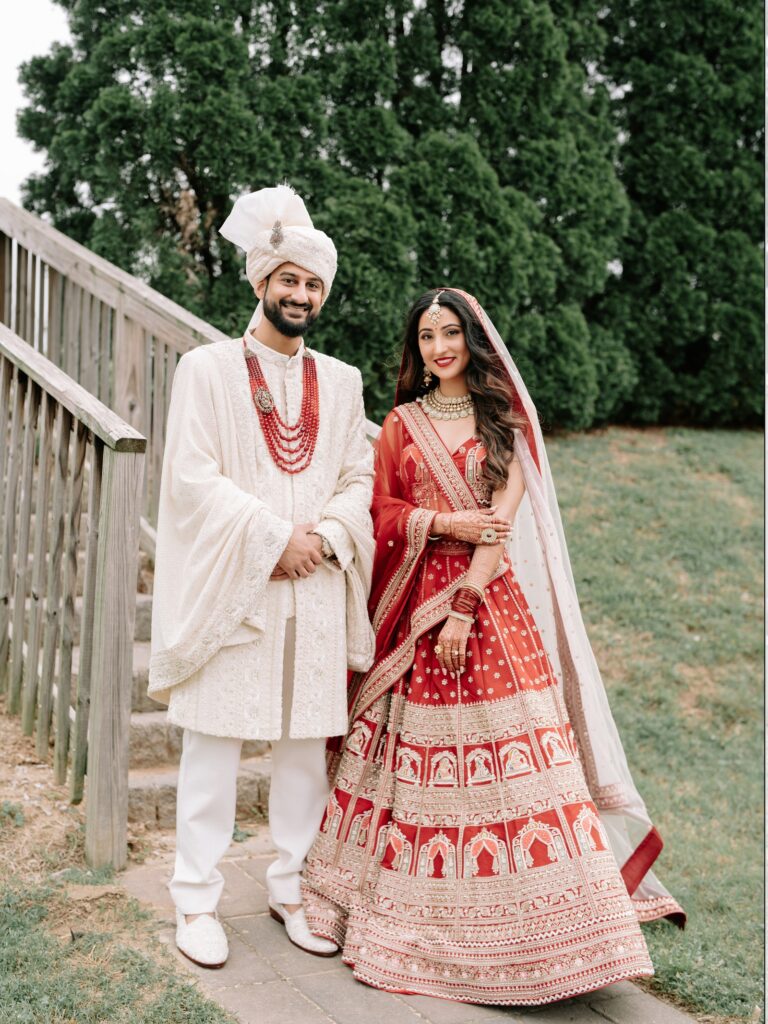 Priya & Dillan’s Gujarati Wedding | Indian Wedding Photographer Atlanta 16 Bride and groom in red and ivory standing on wooden garden steps, Hindu wedding couple portraits