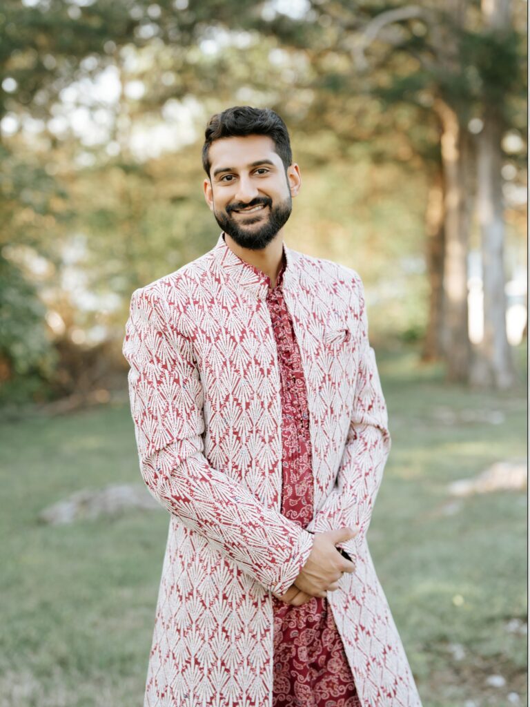 Priya & Dillan’s Gujarati Wedding | Indian Wedding Photographer Atlanta 5 Indian groom in a pink and white embroidered sherwani smiling in a park in Atlanta