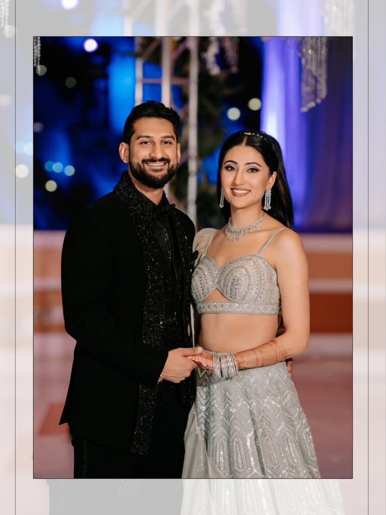Priya & Dillan’s Gujarati Wedding | Indian Wedding Photographer Atlanta 21 Bride in a silver sequin lehenga and groom in a black suit at their Indian wedding reception under a floral ceiling