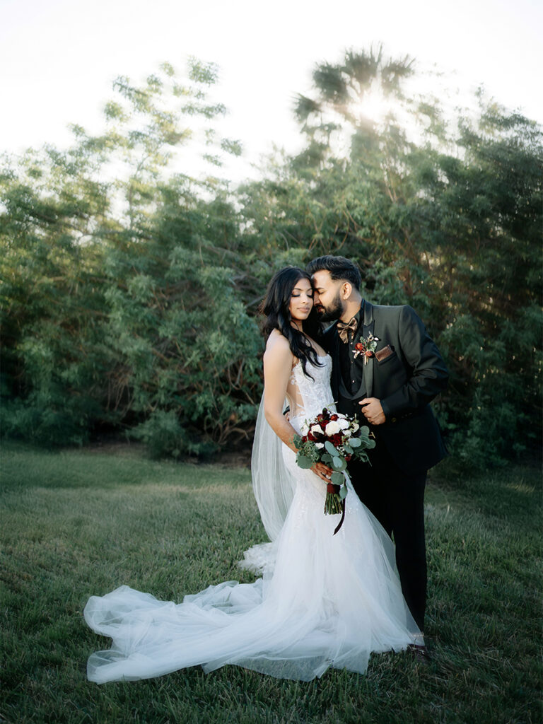 Shobin & Maria’s Malayali Christian Wedding at Grand Hyatt Tampa Bay 10 Kerala Christian bride and groom with a red rose and eucalyptus bouquet in golden light, Tampa wedding photographer Noor K Photography