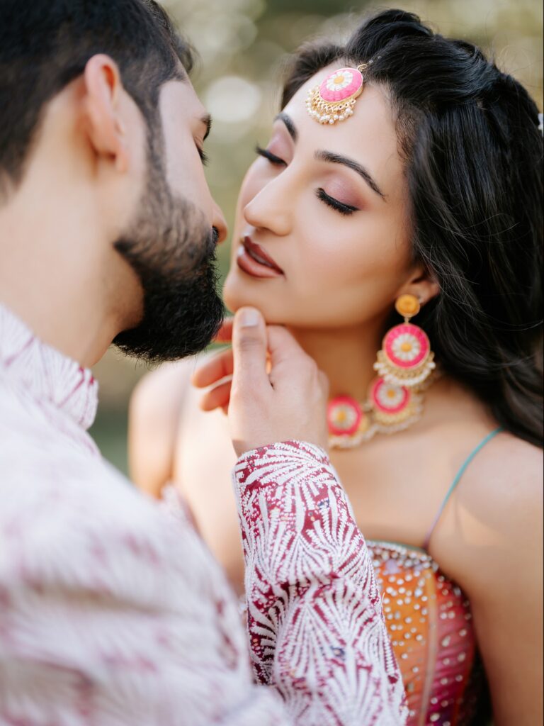 Priya & Dillan’s Gujarati Wedding | Indian Wedding Photographer Atlanta 3 Close-up of the groom holding the bride’s face, the bride in pink jewelry and a maang tikka, Atlanta pre-wedding portrait