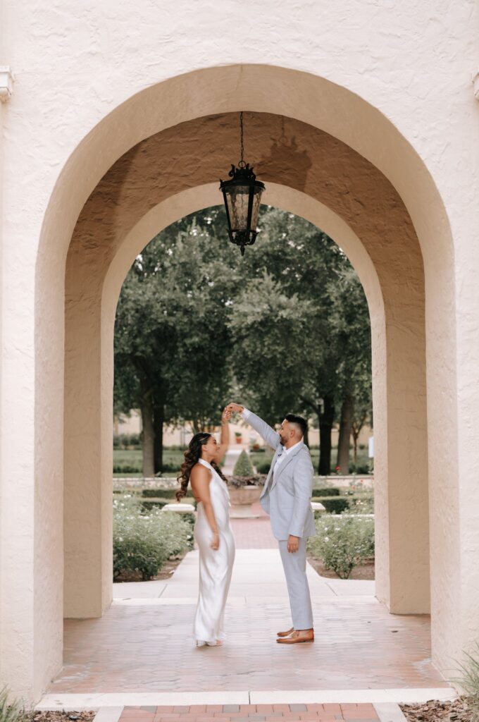 Rahul & Nirali’s Romantic Rollins College Engagement Session 4 Couple dancing beneath a lantern in a Mediterranean archway, Rollins College
