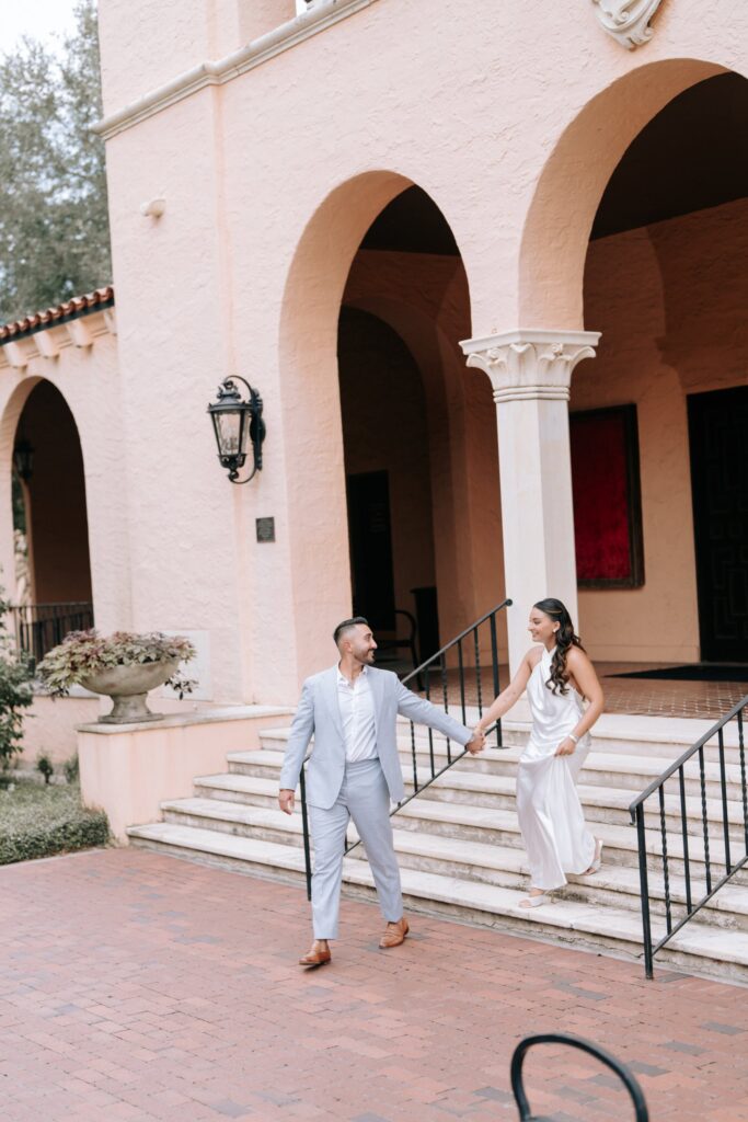 Rahul & Nirali’s Romantic Rollins College Engagement Session 14 Couple walking down the steps of the Annie Russell Theatre at Rollins College