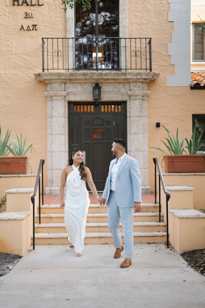 Rahul & Nirali’s Romantic Rollins College Engagement Session 2 Engaged couple walking hand in hand down Spanish-style steps at Rollins College, Winter Park