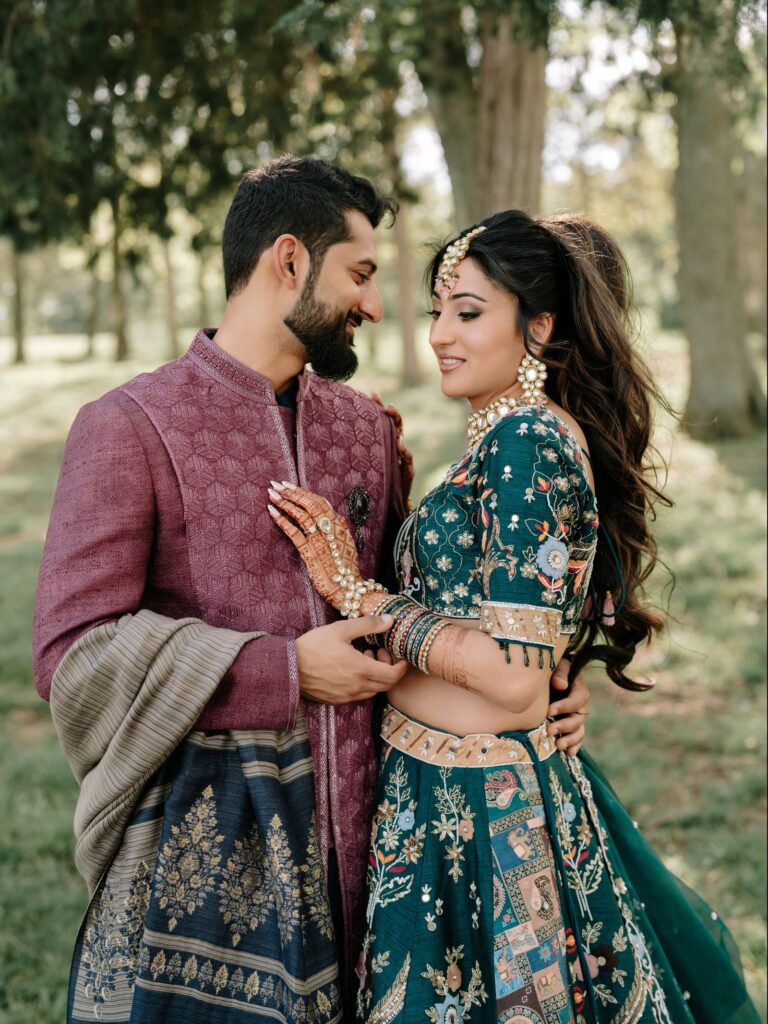 Priya & Dillan’s Gujarati Wedding | Indian Wedding Photographer Atlanta 8 Groom in a plum sherwani holding the bride in a teal lehenga close under the trees, Atlanta pre-wedding portrait