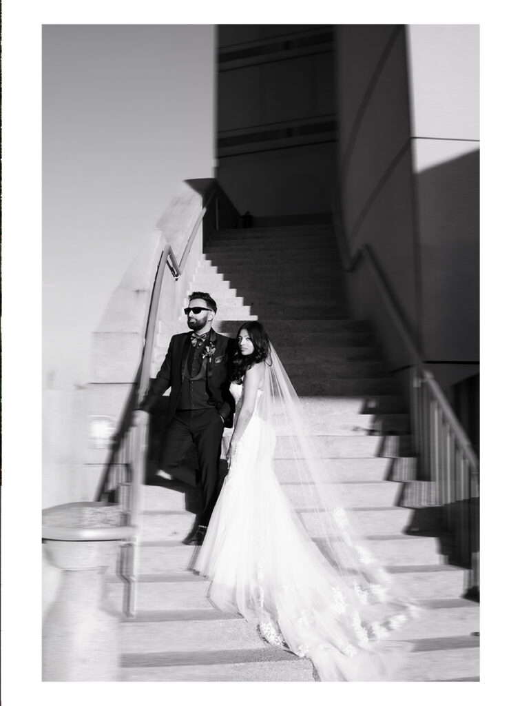 Shobin & Maria’s Malayali Christian Wedding at Grand Hyatt Tampa Bay 8 Black and white portrait of a bride and groom in sunglasses on an outdoor staircase at Grand Hyatt Tampa Bay