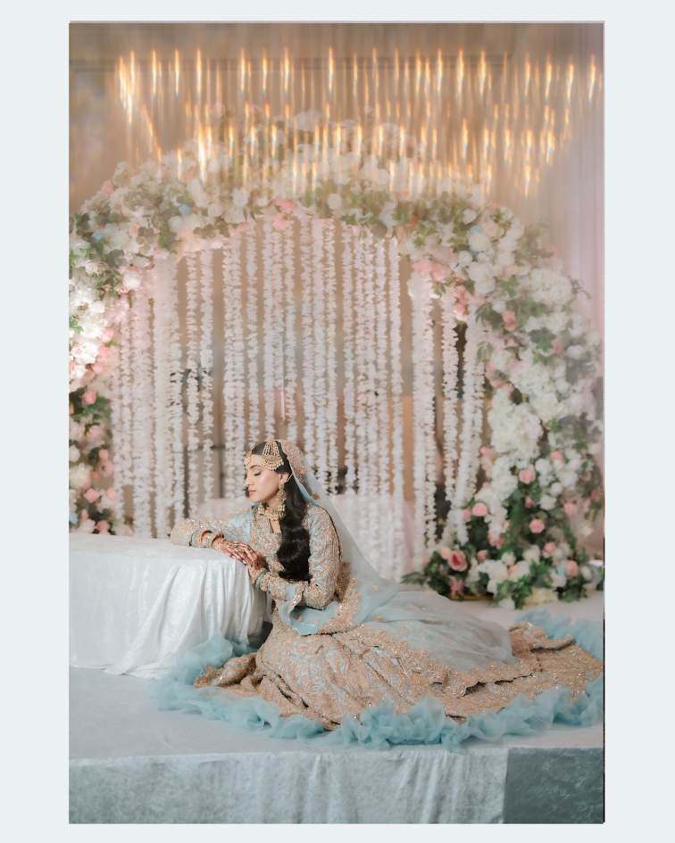 Indian wedding at Hilton Tampa Downtown: bride on a floral nikkah stage under a chandelier