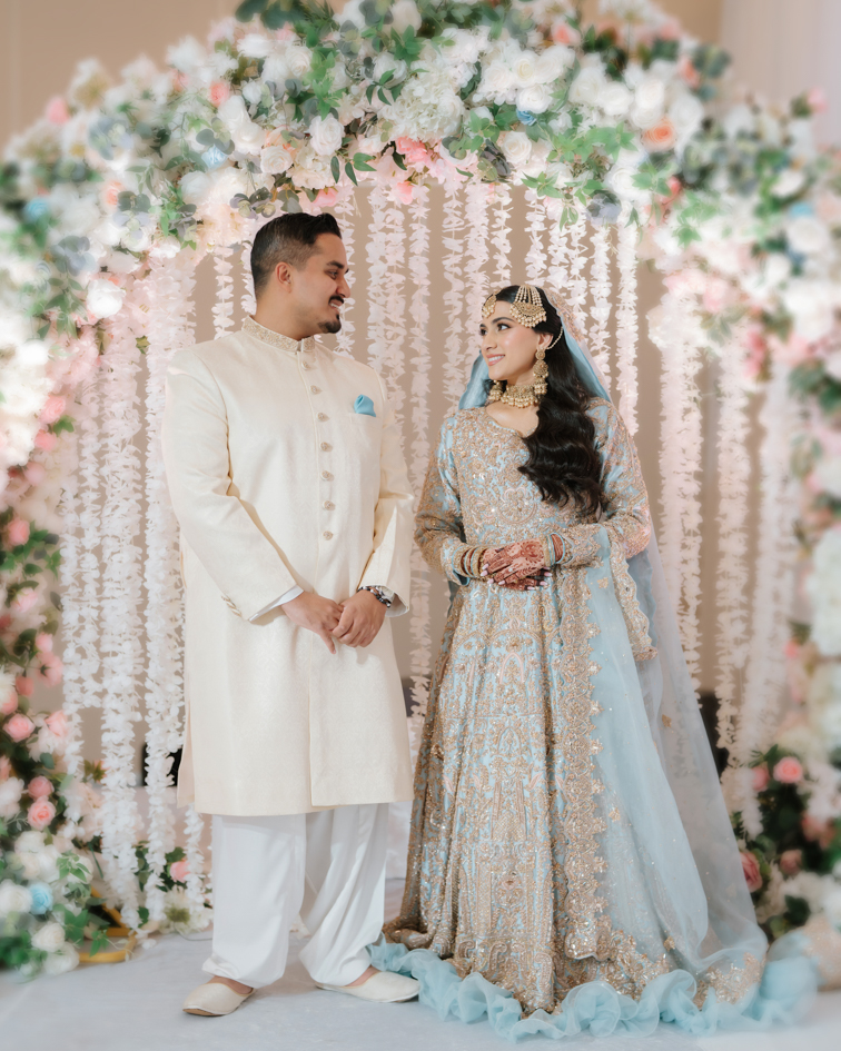 Hanna & Nabeel’s Stunning Nikkah at Hilton Tampa Downtown 8 Hanna and Nabeel under a white and blush floral arch, nikkah photographer Tampa